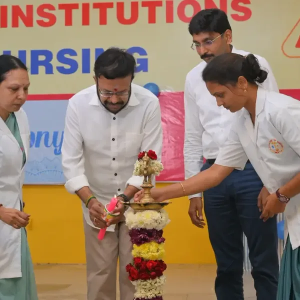 Nursing students and guests lighting a ceremonial lamp