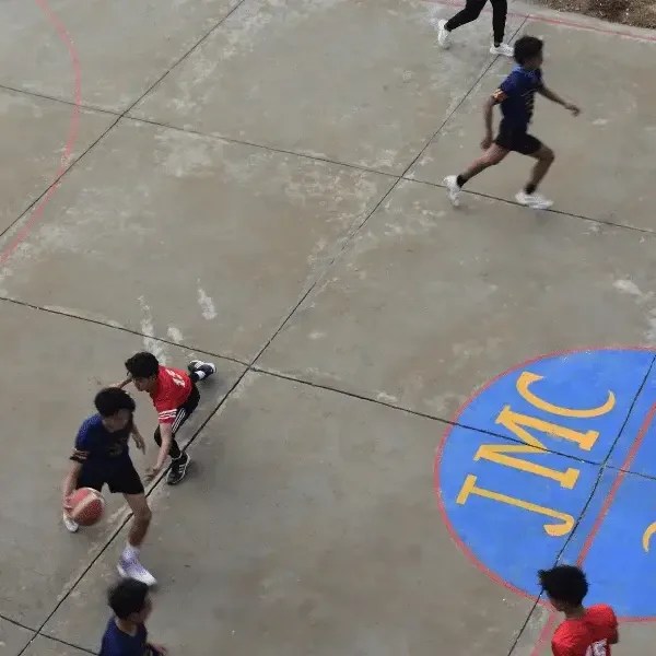 Students playing football on the college court